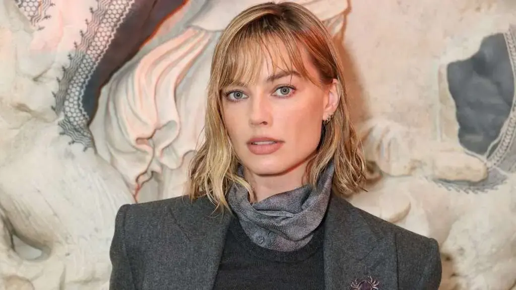 Margot Robbie Stuns in Plunging Top and Chic Chanel Bag During Paris Outing