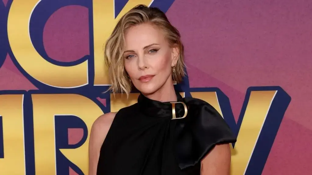 Charlize Theron Showcases Toned Legs in Micro Minidress at Charity Event