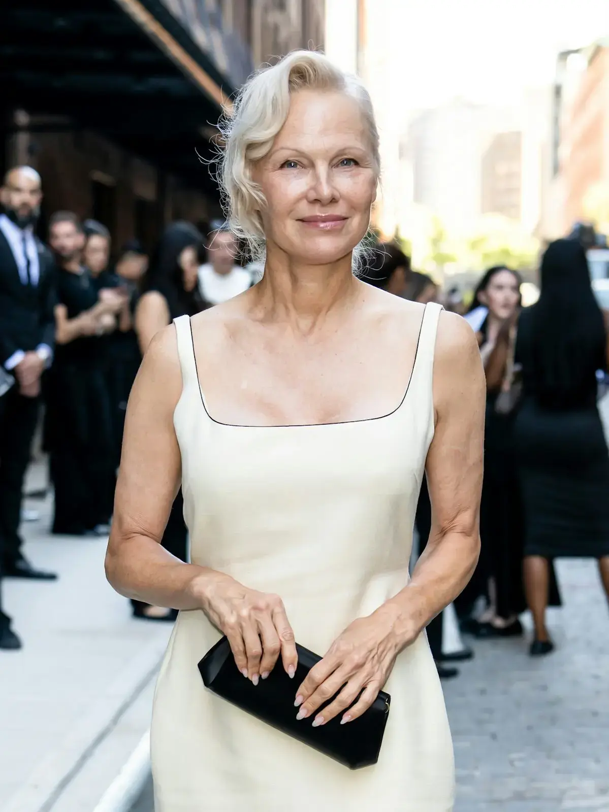 Pamela Anderson Stuns in Ferragamo Gold at Vogue World Milano