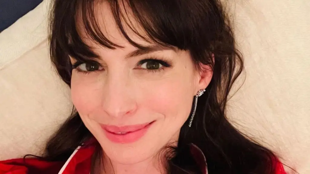 Anne Hathaway Shines in Teal Velvet While Promoting Verity